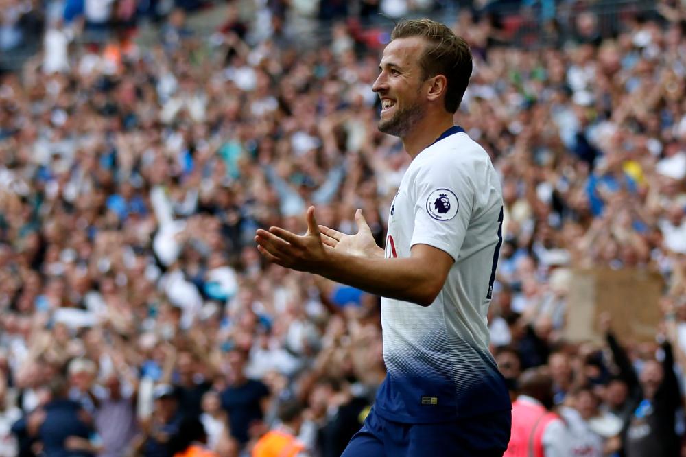 Tottenham Hotspur's striker Harry Kane celebrates after scoring their third goal during the English Premier League football match against Fulham at Wembley Stadium in London, Saturday. — AFP