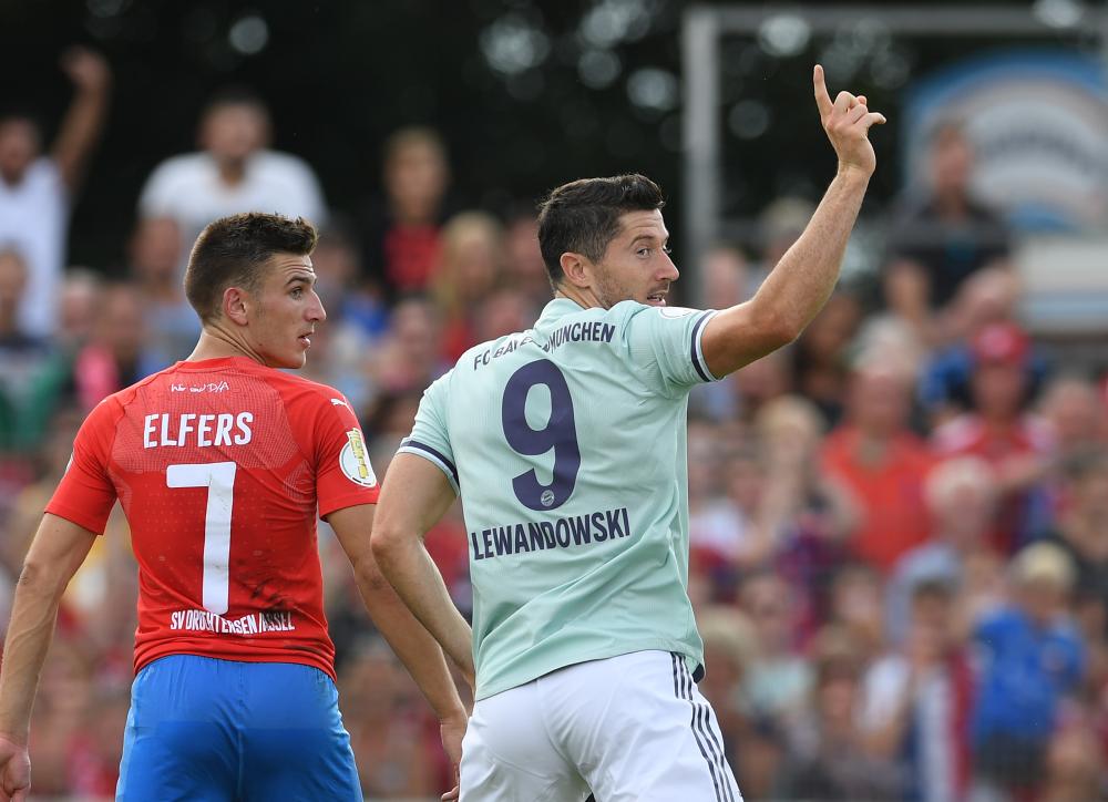 Bayern Munich's Robert Lewandowski (R) celebrates scoring during the German Cup DFB Pokal football match against Drochtersen in Drochtersen Saturday. — AFP