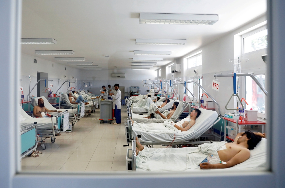 Afghan men who were injured in a recent attack in Kabul and Ghazni province, receive treatment at a hospital in Kabul on Saturday. — Reuters