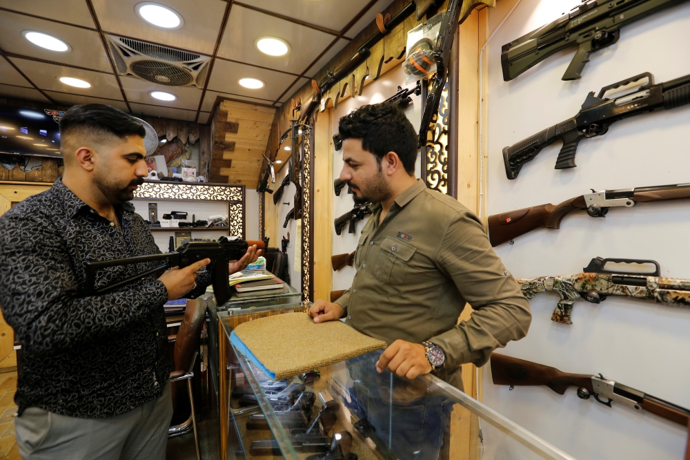 A man checks a weapon before he buys at a weapons shop in Baghdad in this Aug. 12, 2018 file photo. — Reuters