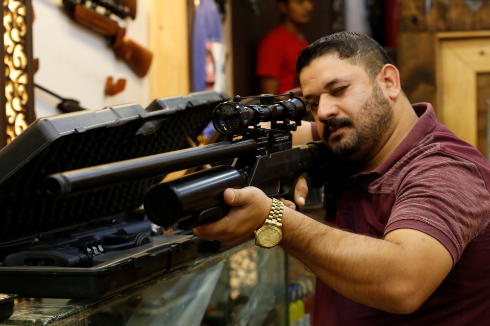 A man checks a weapon before he buys at a weapons shop in Baghdad in this Aug. 12, 2018 file photo. — Reuters