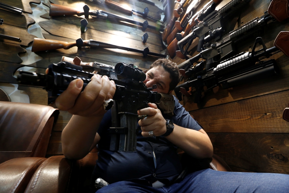 A man checks a weapon before he buys at a weapons shop in Baghdad in this Aug. 12, 2018 file photo. — Reuters