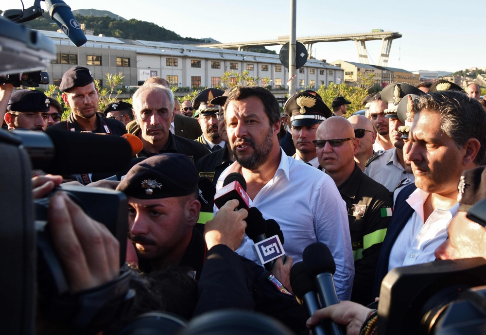 Italy’s Interior Minister Matteo Salvini, center, answers to journalists as he visits the Morandi motorway bridge site one day after a section collapsed in Genoa, Italy, in this Aug. 15, 2018 file photo. — AFP