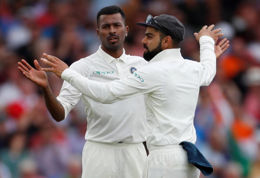 Hardik Pandya celebrates with Virat Kohli after taking the wicket of England's Adil Rashid. — Reuters