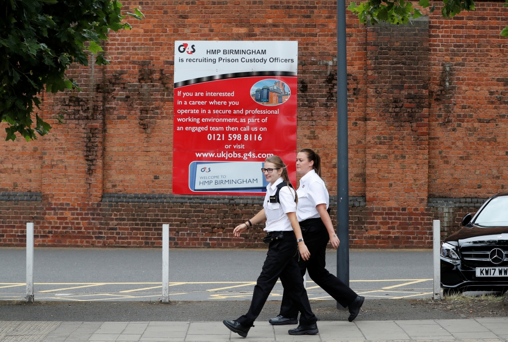 Prison workers enter HMP Birmingham after the British government took over its running from G4S, in Birmingham, Britain, on Monday. — Reuters