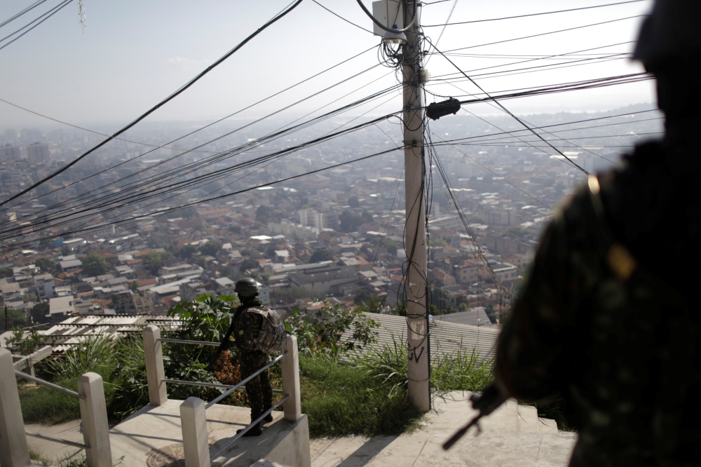 Brazilian Army soldiers patrol the Alemao complex slum during an operation against drug dealers in Rio de Janeiro, Brazil, on Monday. — Reuters