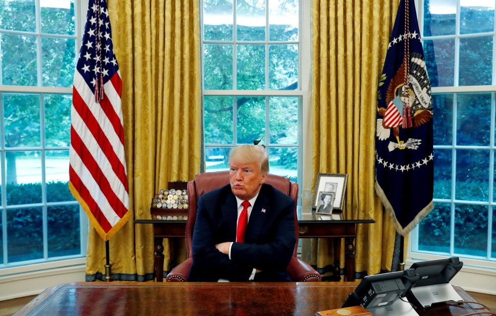 US President Donald Trump reacts to a question during an interview in the Oval Office of the White House in Washington on Monday. — Reuters