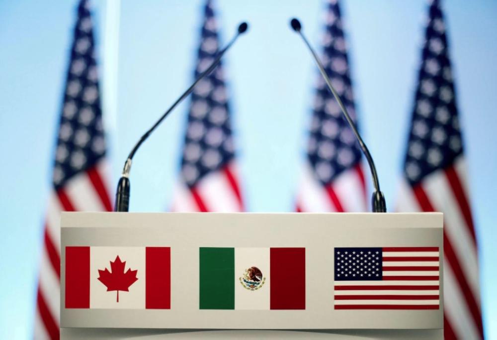 The flags of Canada, Mexico and the US are seen on a lectern before a joint news conference on the closing of the seventh round of NAFTA talks in Mexico City, Mexico, in this file photo. — Reuters