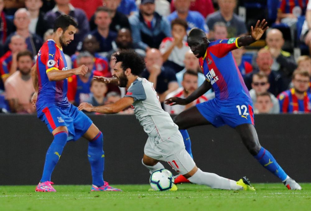 Crystal Palace's Mamadou Sakho concedes a penalty against Liverpool's Mohamed Salah during their English Premier League match at Selhurst Park, London, Monday. — Reuters