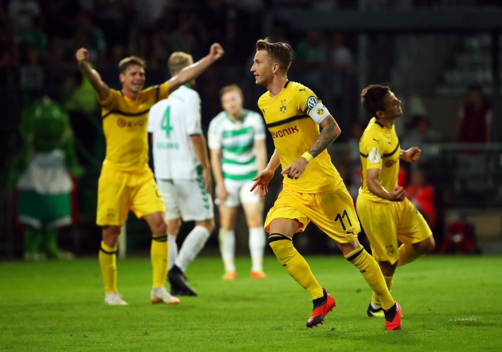Borussia Dortmund's Marco Reus celebrates scoring their second goal against Greuther Fuerth in Fuerth Monday. — Reuters