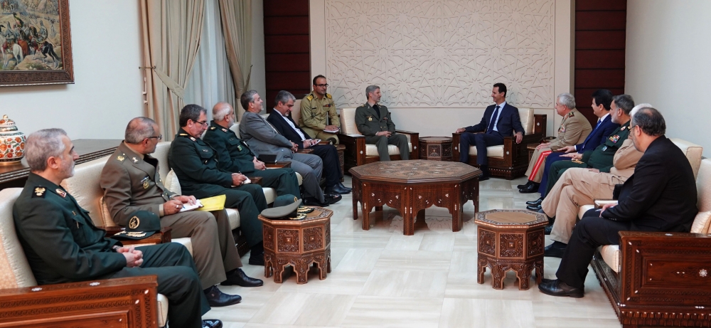 Iranian Defense Minister Amir Hatami, center left, meets with Syrian President Bashar Assad, center right, in Damascus on Sunday. — AFP