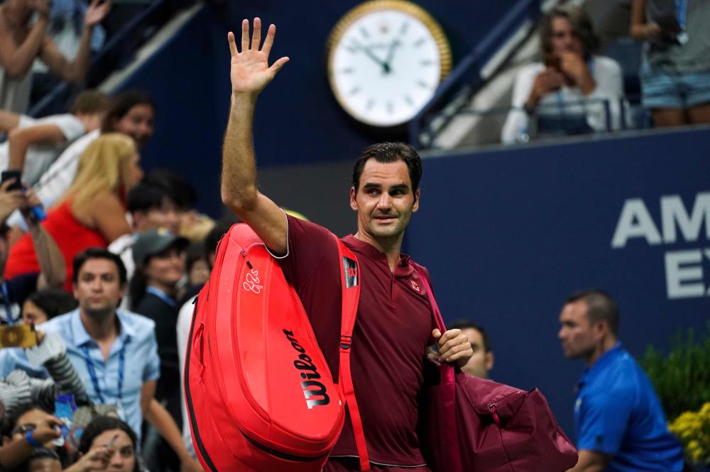 Switzerland's Roger Federer waves as he walks off court after losing his 2018 US Open match against Australia's John Millman at the USTA Billie Jean King National Tennis Center in New York Monday. — AFP