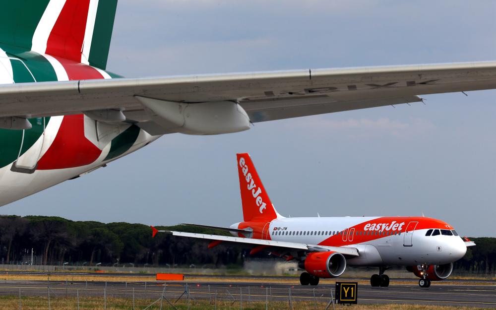 An EasyJet airplane and an Alitalia airplane are seen on the tarmac at the Leonardo da Vinci-Fiumicino Airport in Rome, Italy, in this file photo. — Reuters