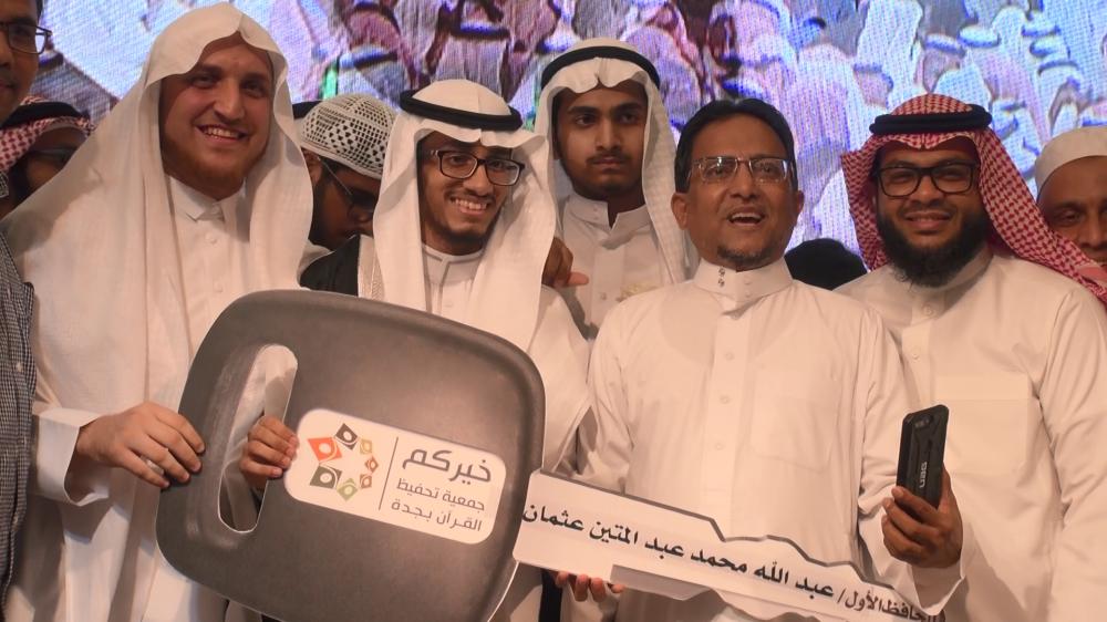 Abdullah Abdul Mateen Usmani, the winner of the Quran competition, is flanked by friends on the left and father (mobile phone in hand)  and Sheikh Hamza Al-Rayyan, imam of the Aziziyah Mosque. 