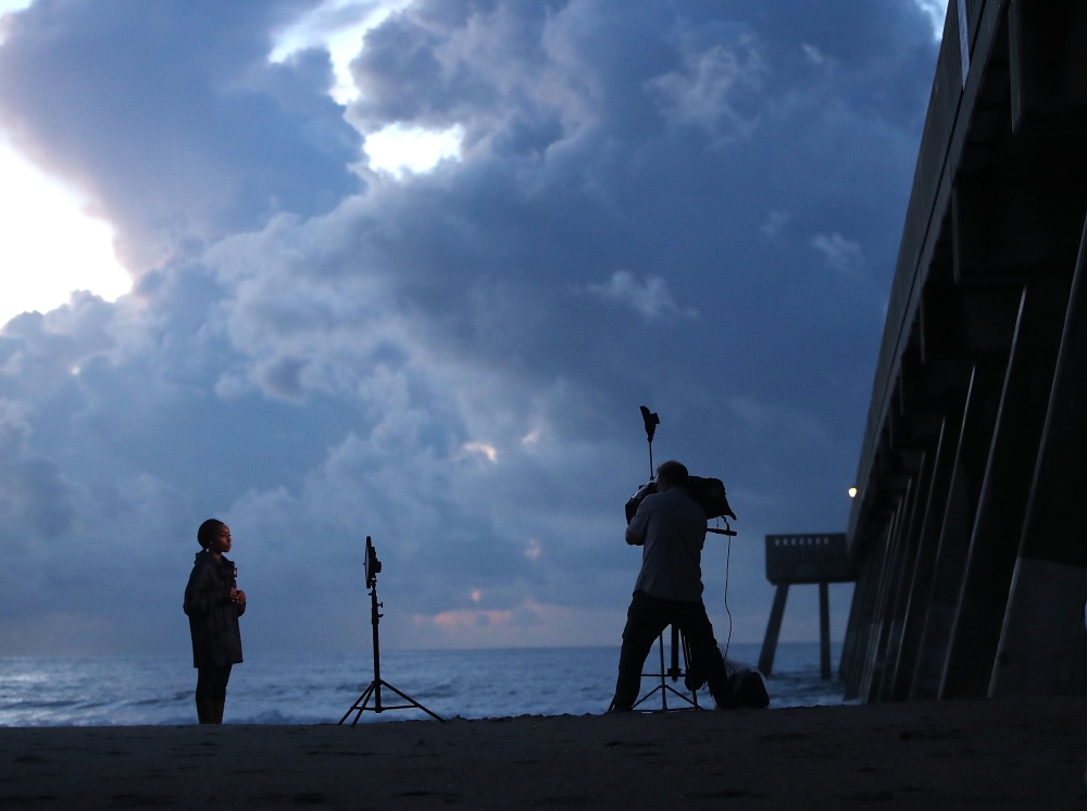 Members of the media report from from the Wrightsville Beach Pier ahead of the expected arrival of Hurricane Florence in Wrightsville Beach, North Carolina, on Wednesday. — AFP