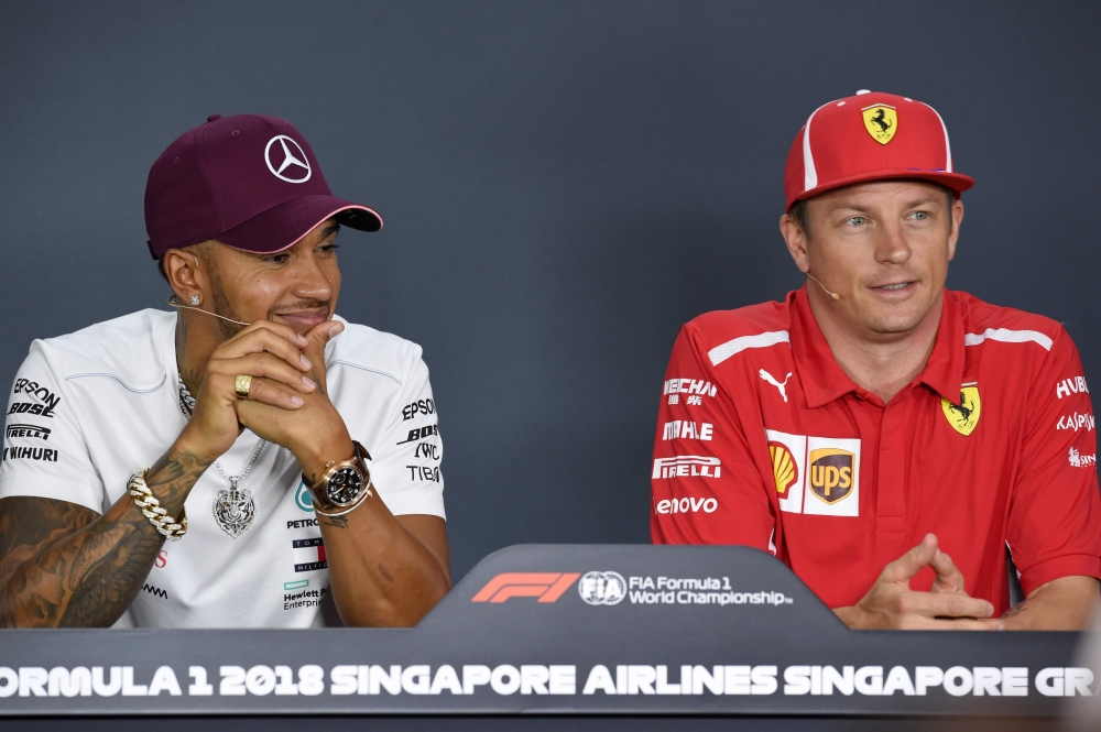 Mercedes' British driver Lewis Hamilton (L) and Ferrari's Finnish driver Kimi Raikkonen attend a press conference ahead of the Singapore Formula One Grand Prix at the Marina Bay Street Circuit in Singapore on Thursday. — AFP