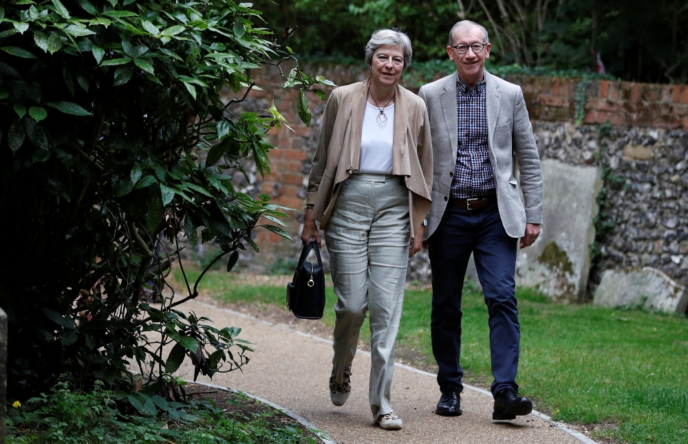 Britain's Prime Minister Theresa May and her husband Philip arrive at church, in Sonning, Britain, Sunday. — Reuters