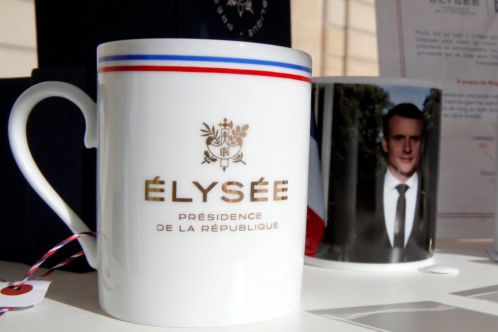 A mug with a picture of French President Macron and the Elysee Palace logo to launch the presidential brand named ''Elysee Presidence de la Republique'' is seen in the courtyard of the Elysee Palace as part of the European Heritage Days event in Paris, France on Sunday. - Reuters