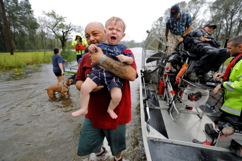 Oliver Kelly, 1-year-old, cries as he is carried off the sheriff’s airboat during his rescue from rising flood waters in the aftermath of Hurricane Florence in Leland, North Carolina, on Sunday. — Reuters