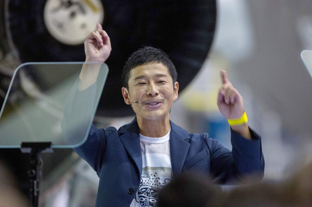 


Japanese billionaire Yusaku Maezawa reacts during the announcement by Elon Musk to be the first private passenger who will fly around the Moon aboard the SpaceX BFR launch vehicle, at the SpaceX headquarters and rocket factory in Hawthorne, California, on Monday. — AFP