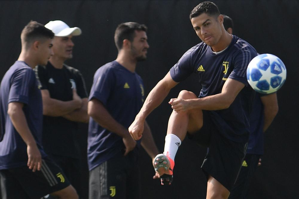 


Juventus' forward Cristiano Ronaldo kicks the ball during a training session in Turin Tuesday. — AFP 