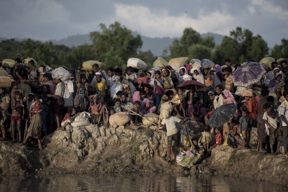 


This file photo taken on October 10, 2017, shows Rohingya refugees fleeing from Myanmar arrive at the Naf river in Whaikyang, Bangladesh border. In a final report released on Sept. 18, a UN probe says six members of Myanmar’s military including commander-in-chief Senior General Min Aung Hlaing and Vice Senior General Soe Win should be investigated for ‘genocide’ against the Rohingya after more than 700,000 from the Muslim minority were driven into Bangladesh since August last year. — AFP