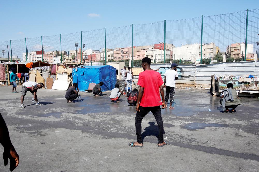 


African migrants gather near a makeshift home on the outskirts of Casablanca, Morocco. 