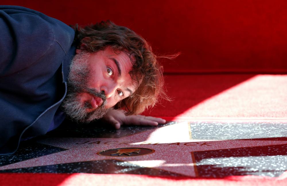 


Actor Jack Black kisses his star at its unveiling on the Hollywood Walk of Fame in Los Angeles, California on Wednesday. - Reuters