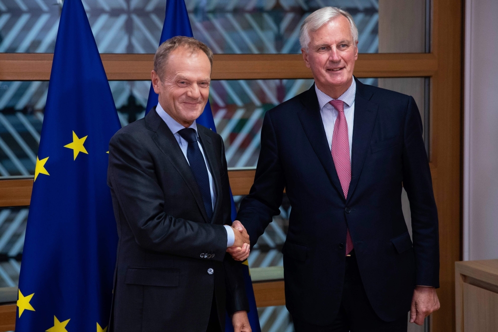 European Council President Donald Tusk, left, shakes hands with EU chief Brexit negotiator Michel Barnier before their meeting at the European Council building in Brussels in this Sept. 13, 2018 file photo. — AFP