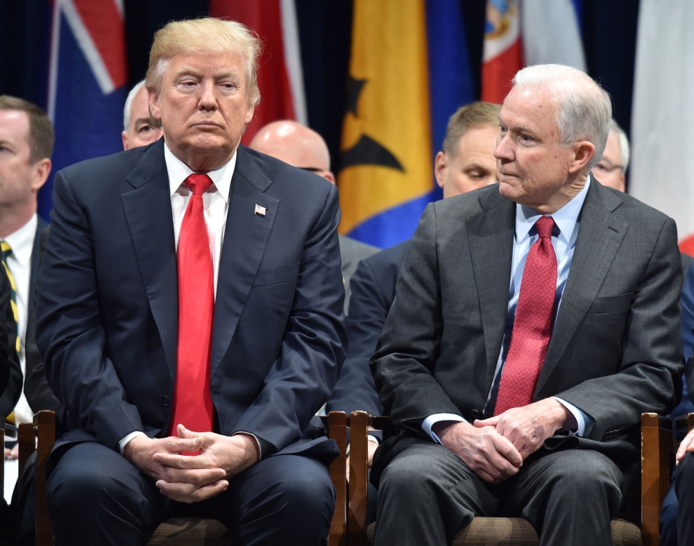 US President Donald Trump, left, sits with Attorney General Jeff Sessions in Quantico, Virginia, in this Dec. 15, 2017 file photo. — AFP