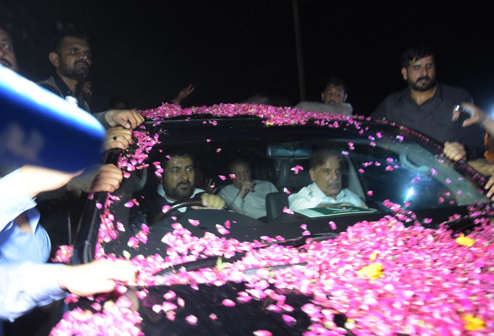 Former Pakistani Prime Minister Nawaz Sharif, center back, sits in a vehicle alongside his younger brother Shahbaz Sharif, right, following his release from Adiala prison in Rawalpindi on Wednesday. — AFP
