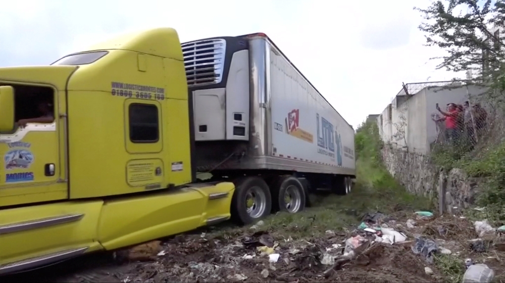 A truck leaves with an abandoned trailer full of bodies that has been parked in Tlajomulco de Zuniga, Jalisco, Mexico, on this Sept. 15, 2018 in this still image taken from a video obtained on Sept. 17, 2018. — Reuters