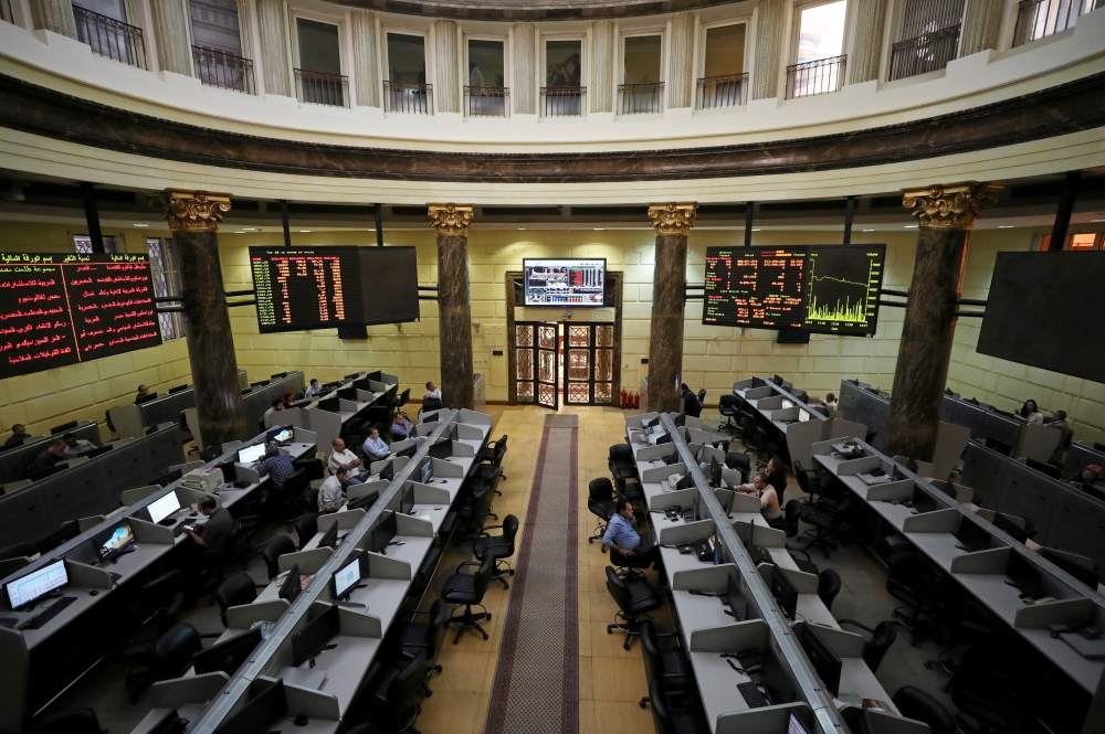 Traders work at the Egyptian stock exchange in Cairo on Thursday. — Reuters