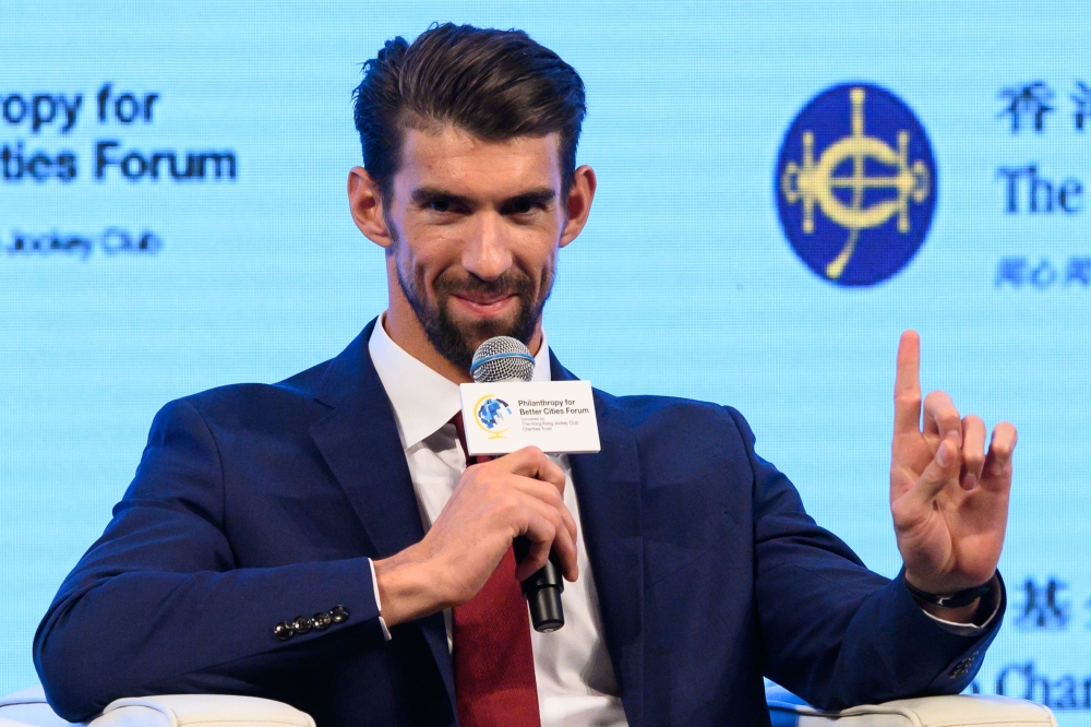 US Olympic swimming legend Michael Phelps speaks as part of a panel during the Philanthropy for Better Cities Forum event in Hong Kong on Friday. — AFP