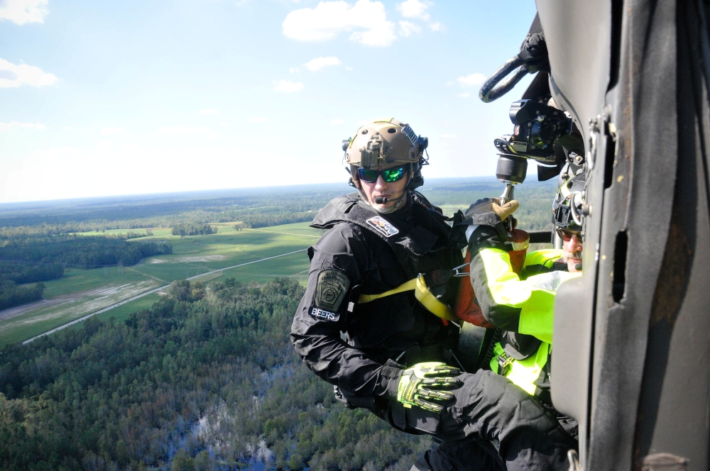 Waterway Conservation Officer Anthony Beers, with the Pennsylvania Helicopter Aquatic Rescue Team, prepares to conduct an aerial rescue on a hoist from a Pennsylvania National Guard Black Hawk helicopter in Nichols, South Carolina, in this Sept. 19, 2018 file photo. — Reuters
