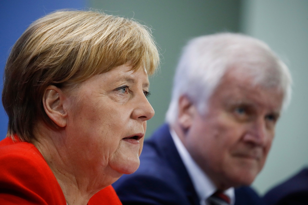 German Chancellor Angela Merkel and German Federal Minister of the Interior, Building and Community Horst Seehofer hold a joint press conference after a meeting on the housing situation at the Chancellery in Berlin on Friday. — AFP