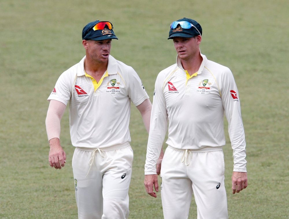 File photo shows Australia's David Warner and Steve Smith leaving the pitch after beating South Africa in the first Test at the Kingsmead Stadium, Durban, South Africa. — Reuters