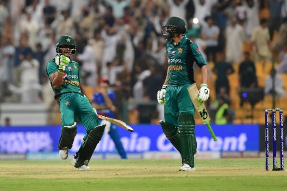 Pakistan's Hasan Ali (left) celebrates with Shoaib Malik after Pakistan pulls off a last over victory over Afghanistan. 