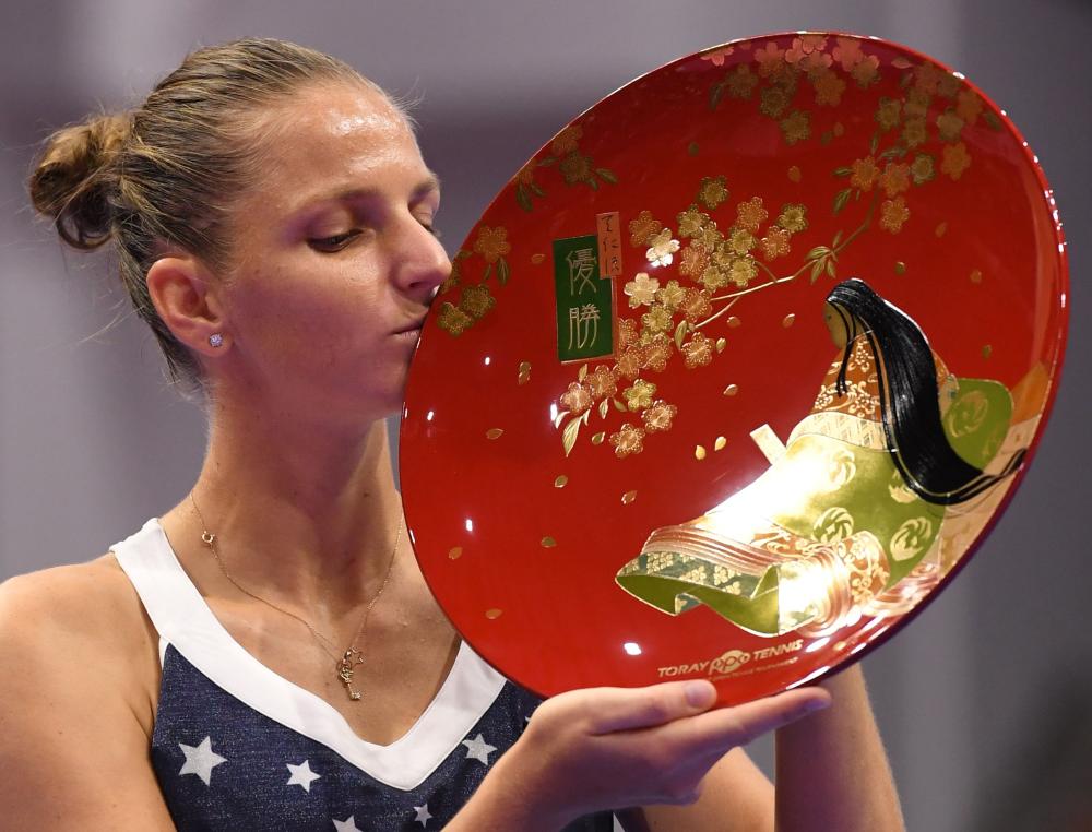 Karolina Pliskova of the Czech Republic kisses her trophy after beating Japan’s Naomi Osaka in the final of the Pan Pacific Open Tennis Tournament in Tokyo Sunday. —AFP 