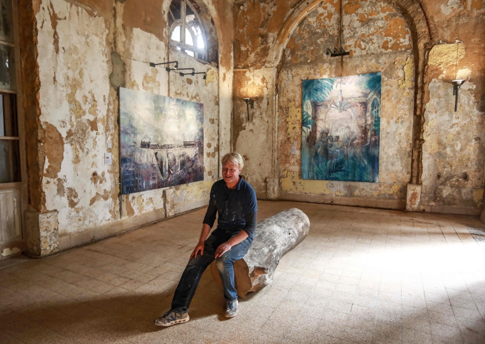 Visitors view paintings by 45-year-old British artist Tom Young during an exhibition at the Sofar Grand Hotel in the Lebanese village of Sofar, some 30 km east of Beirut, in this Sept. 21, 2018 file photo. — AFP