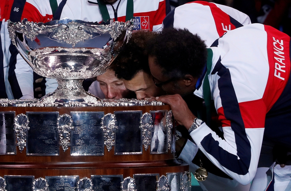 France captain Yannick Noah and Jo-Wilfried Tsonga kiss the trophy after winning the Davis Cup Final against Belgium at Stade Pierre Mauroy, Lille, France, in this file photo. — Reuters