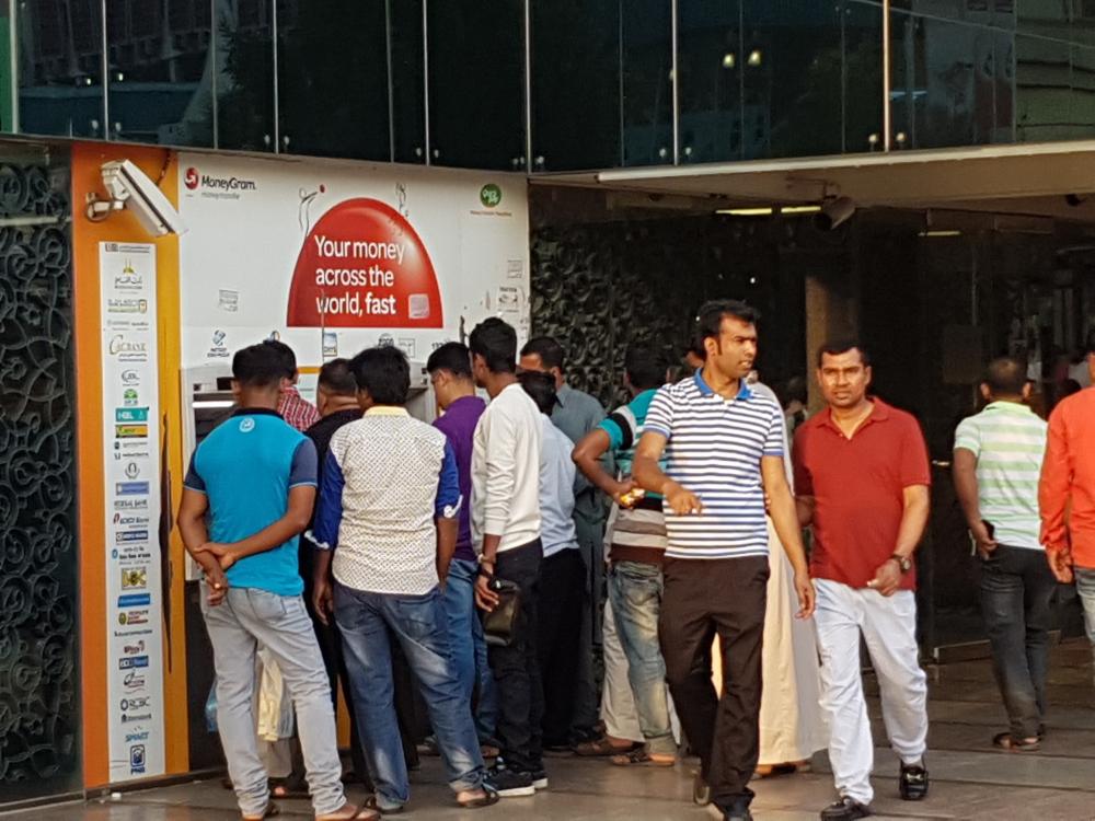 


Expatriate workers queue up in front of a money remittance center in Jeddah on Monday to send money home. — SG photo by Irfan Mohammed