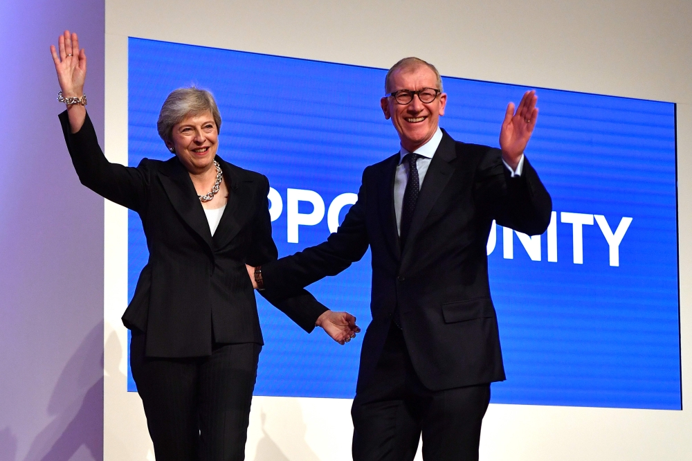 Britain's Prime Minister Theresa May, left, waves with her husband Philip after giving her keynote address on the fourth and final day of the Conservative Party Conference 2018 at the International Convention Centre in Birmingham, central England, on Wednesday. — AFP