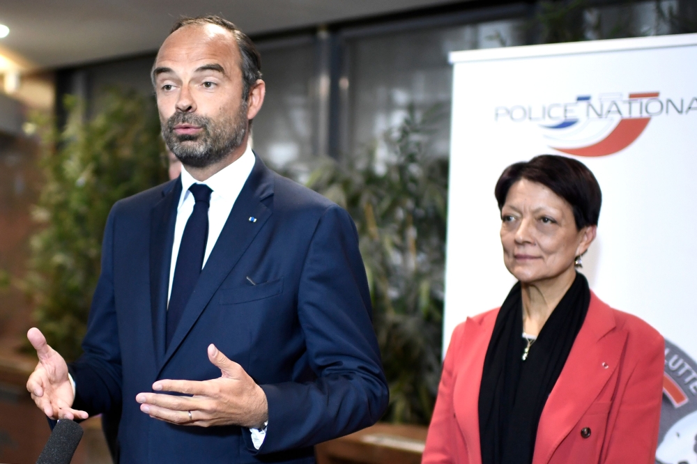 French Prime Minister Edouard Philippe, left, gives a joint press conference with Mireille Ballestrazzi, central director of the judicial police in Nanterre, north of Paris, on Wednesday after French police arrested notorious French robber Redoine Faid on the run for three months after an audacious Hollywood-style helicopter jailbreak. — AFP