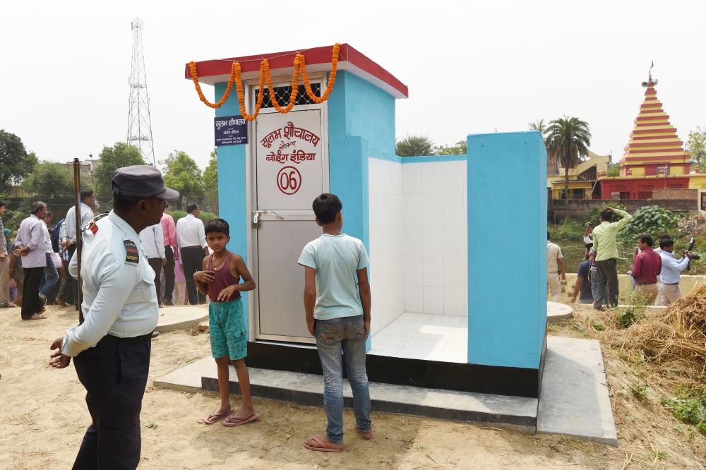 


A private security guard and villagers gather around a newly built public toilet by Boeing India, under its Corporate Social Responsibility (CSR) activity, at Sarisabpahi Village in Madhubani district in Bihar, in this April 8, 2018 file photo. — AFP