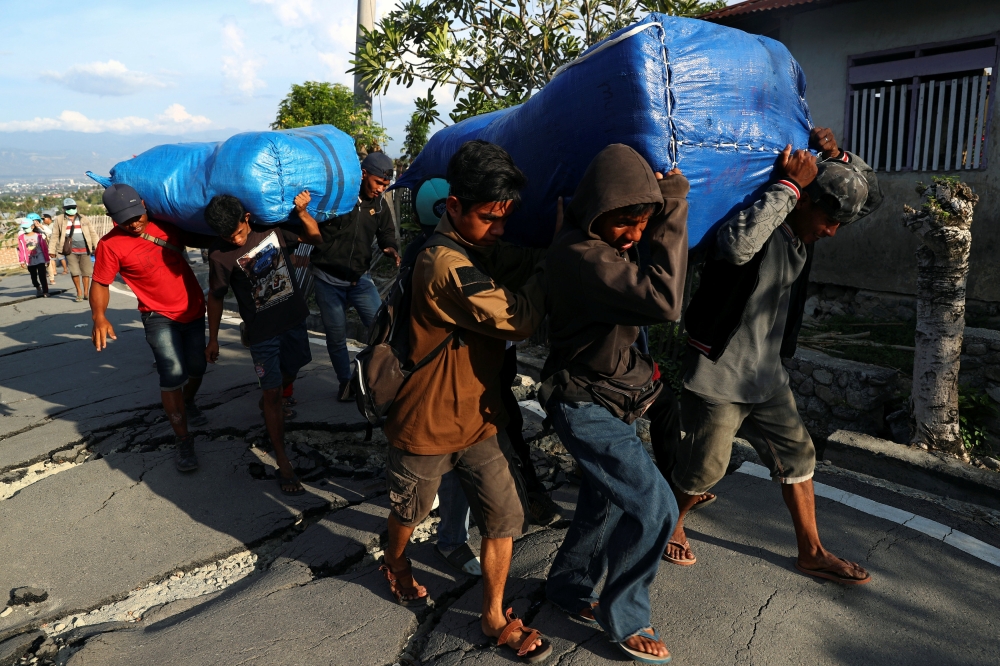A resident walks at an area hit by the earthquake and tsunami in Palu, Central Sulawesi, Indonesia, on Thursday. — Reuters