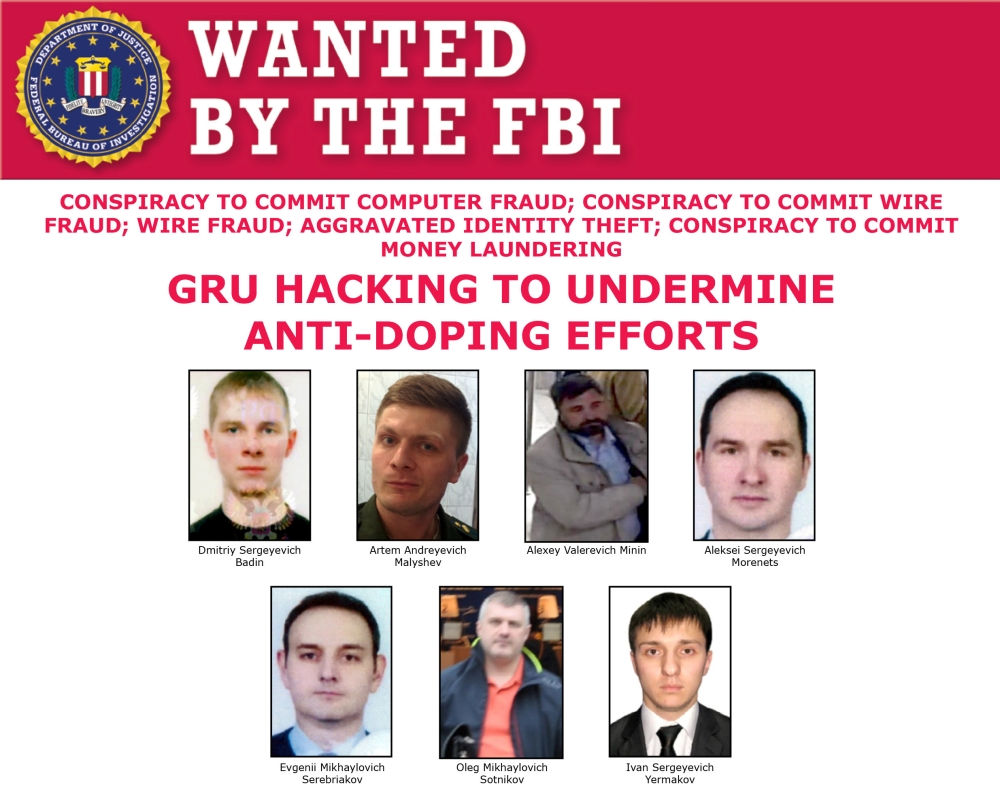 A US Federal Bureau of Investigation (FBI) poster shows photographs of seven men identified as Russian intelligence officers who were indicted in Washington on Thursday. — Reuters