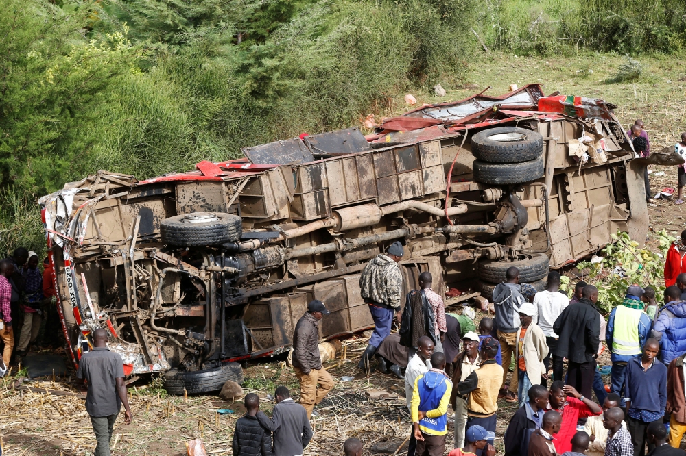 Residents look at the wreckage of a bus that crashed, near Fort Ternan along the Londiani-Muhoroni road in Kericho county, Kenya on Wednesday. — Reuters