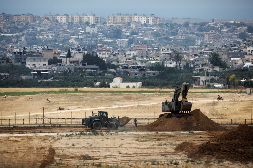 Israeli bulldozers work on a position on the Israeli side of the border fence between Israel and the Gaza Strip in this May 15, 2018 file photo. — Reuters