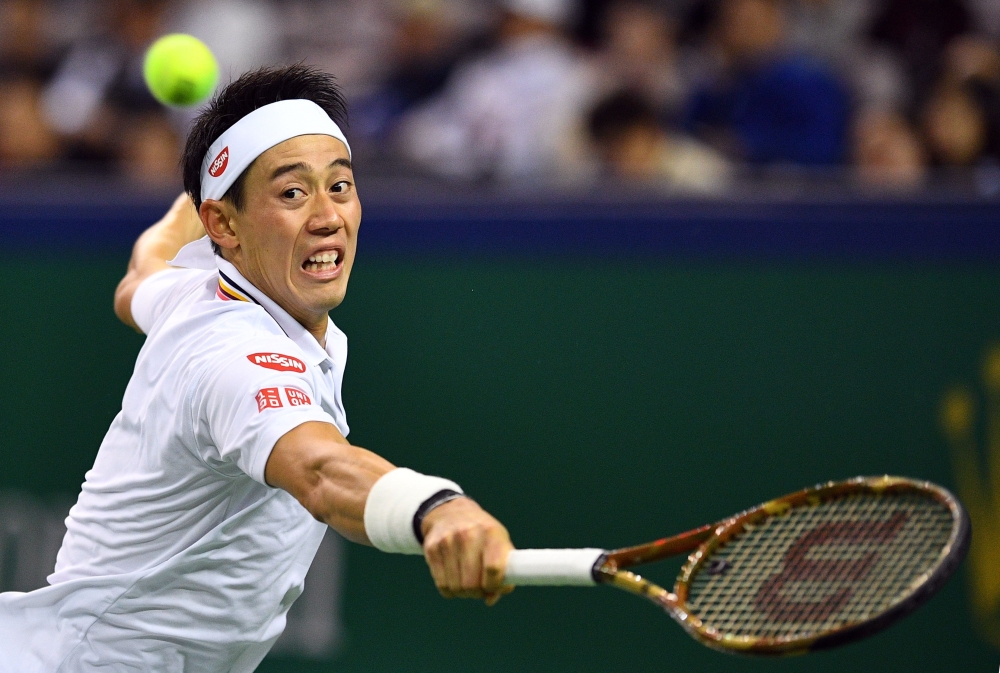 Kei Nishikori of Japan hits a return against Roger Federer of Switzerland during their men's singles quarterfinal match at the Shanghai Masters tennis tournament on Friday. — AFP